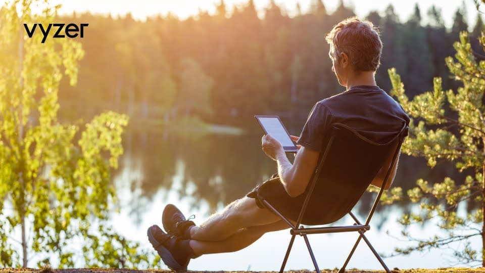 Man reading a book by a lake, representing top summer 2024 reads for passive investors.